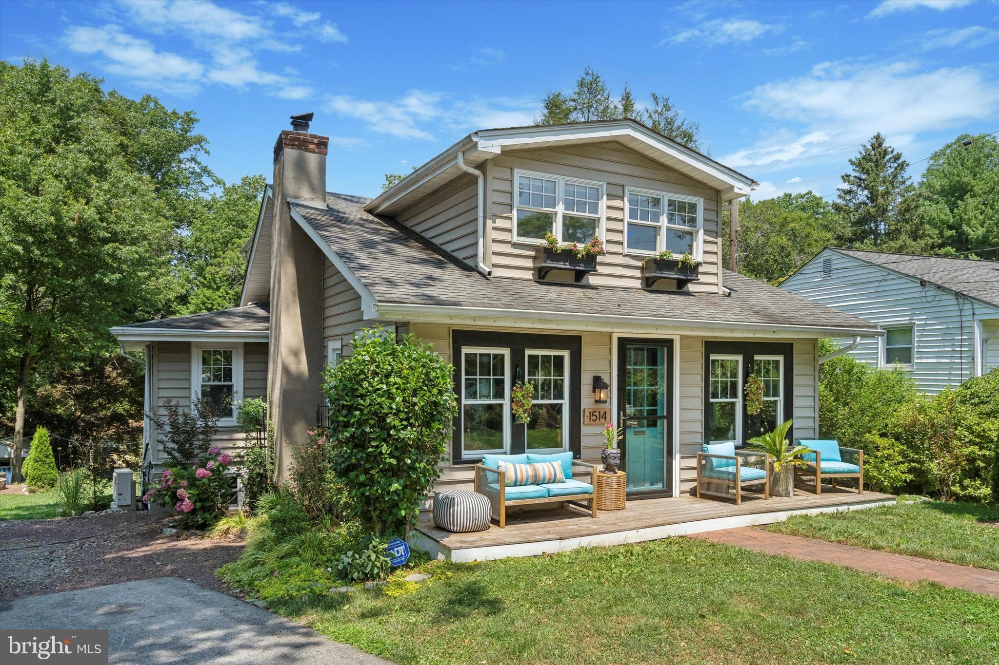 a front view of a house with garden and porch