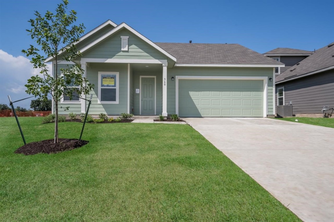 a front view of a house with a yard and porch