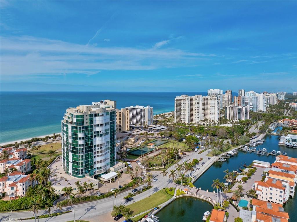 Birds eye view of property with a water view