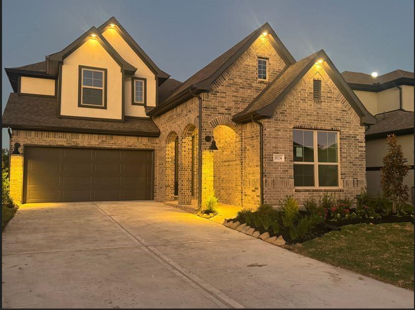 Beautiful brick and stucco elevation evening shot.  The arches add a very nice architectural touch.