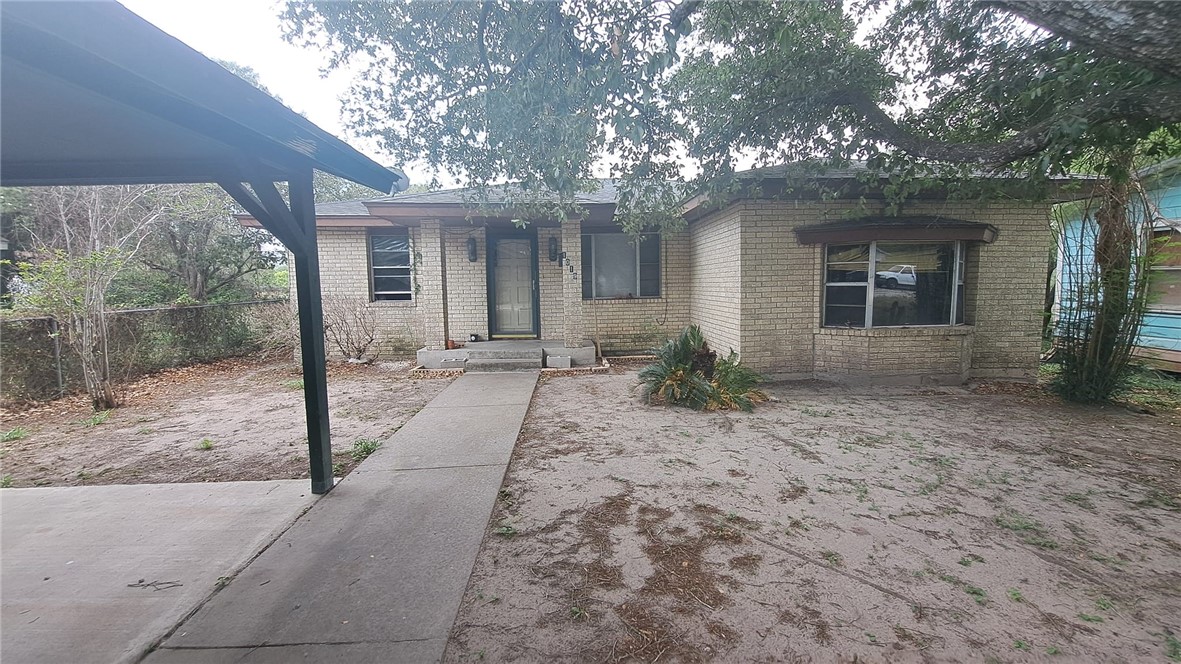 a view of a house with a tree in front