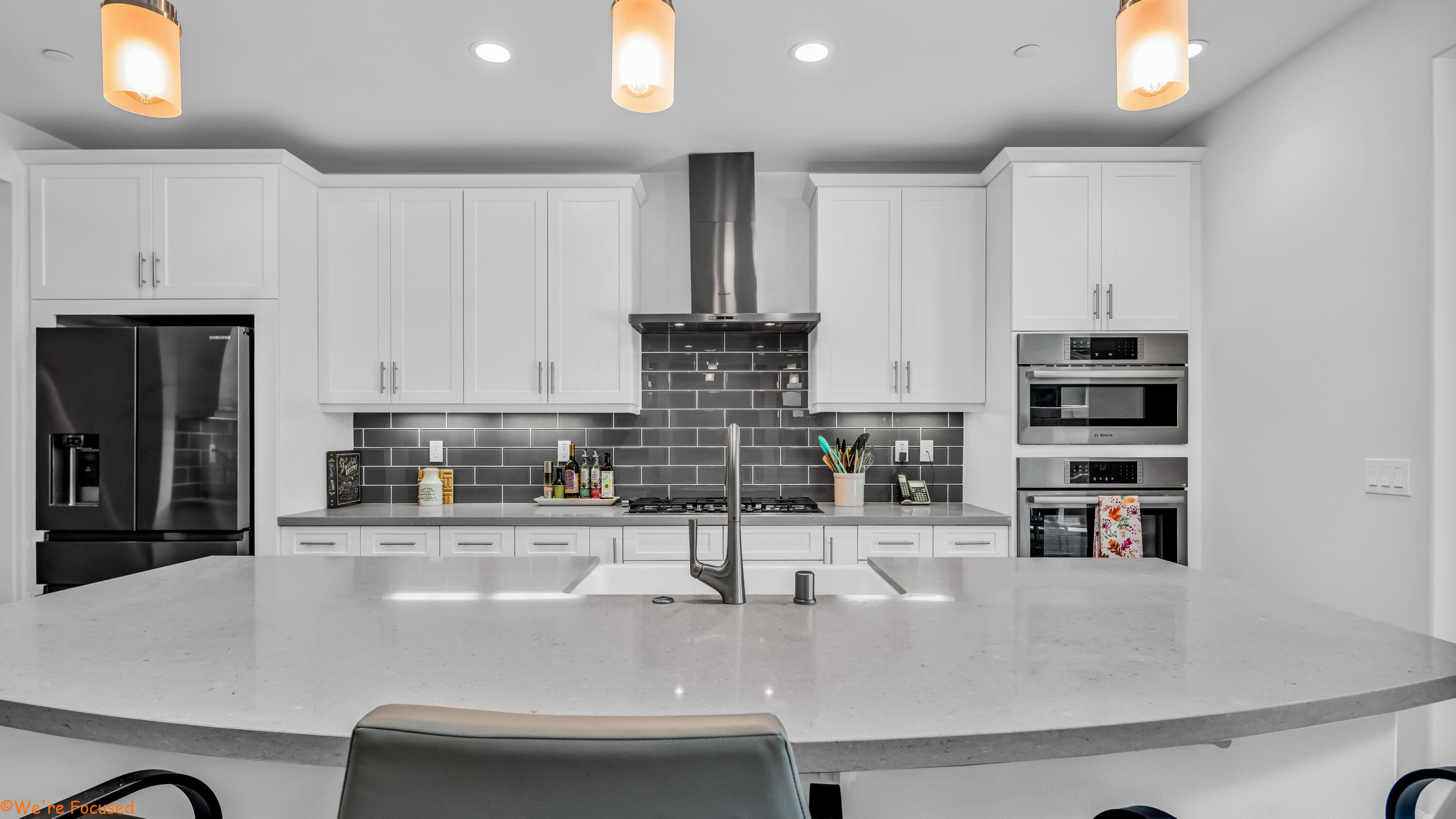 a kitchen with kitchen island a sink stainless steel appliances and cabinets