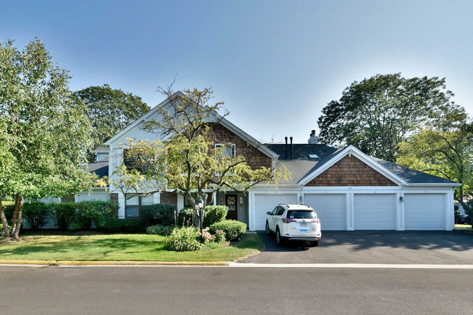 a car parked in front of house with a yard