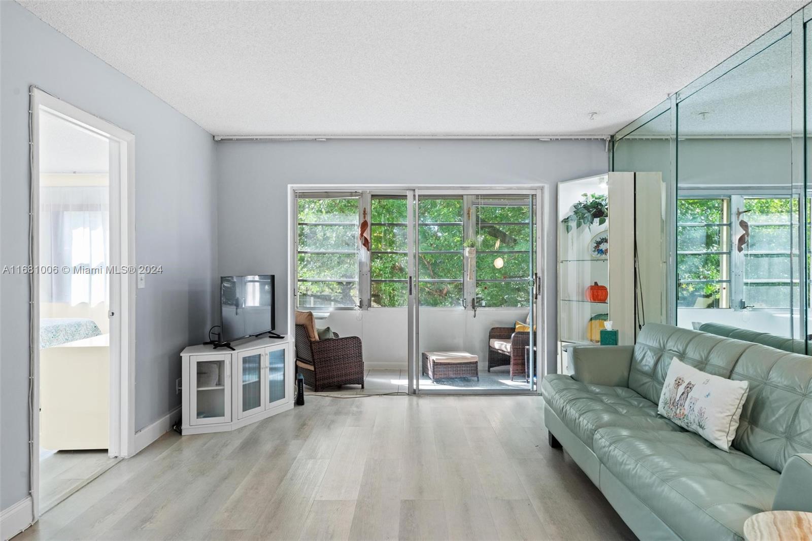 a living room with furniture and large windows