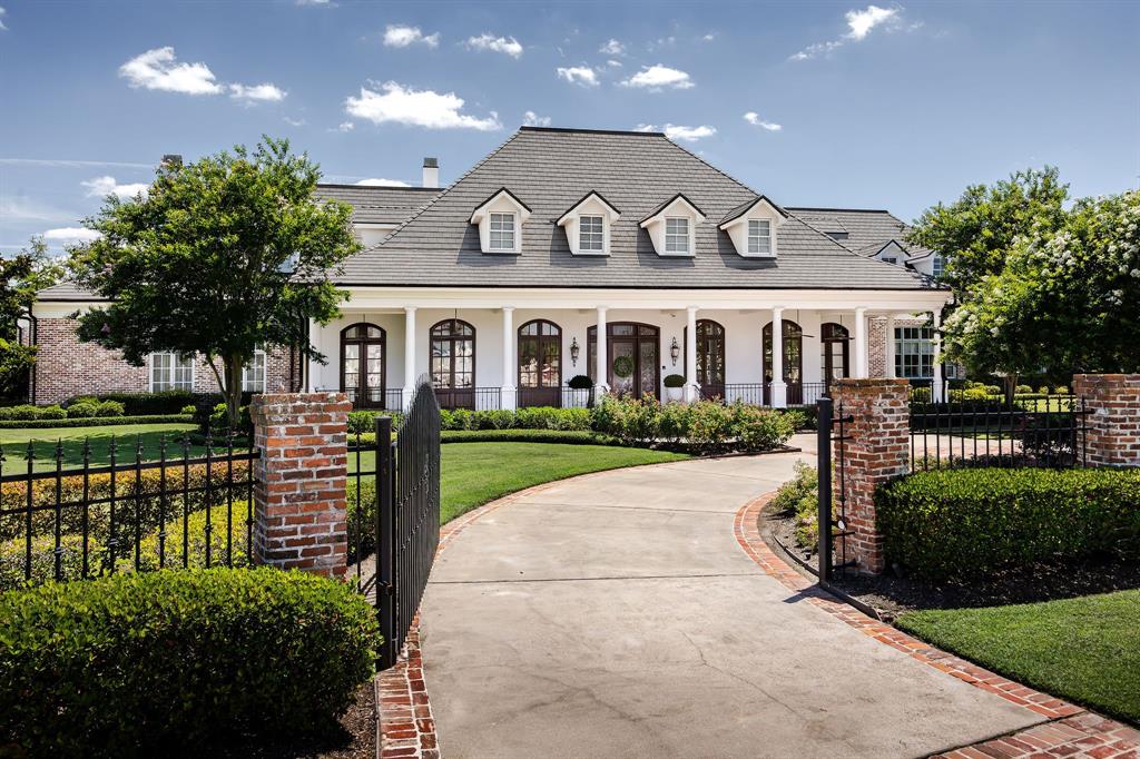 a front view of a house with a garden and plants