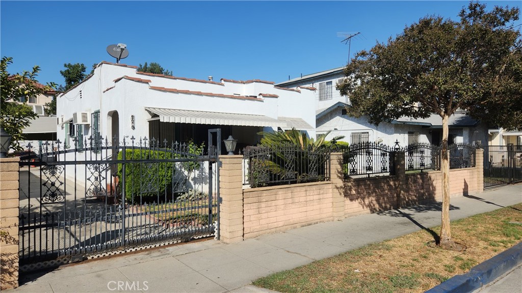 a view of a white building with a porch