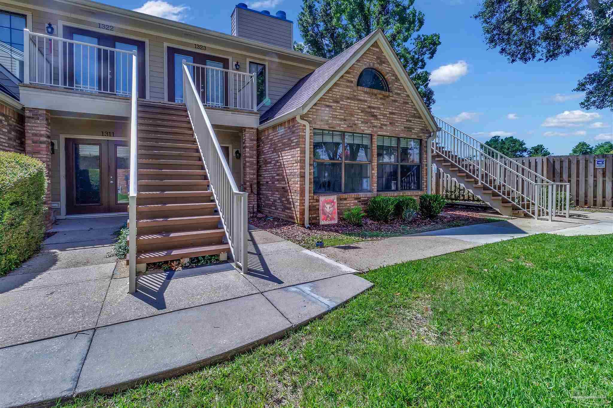 a view of a house with backyard porch and sitting area