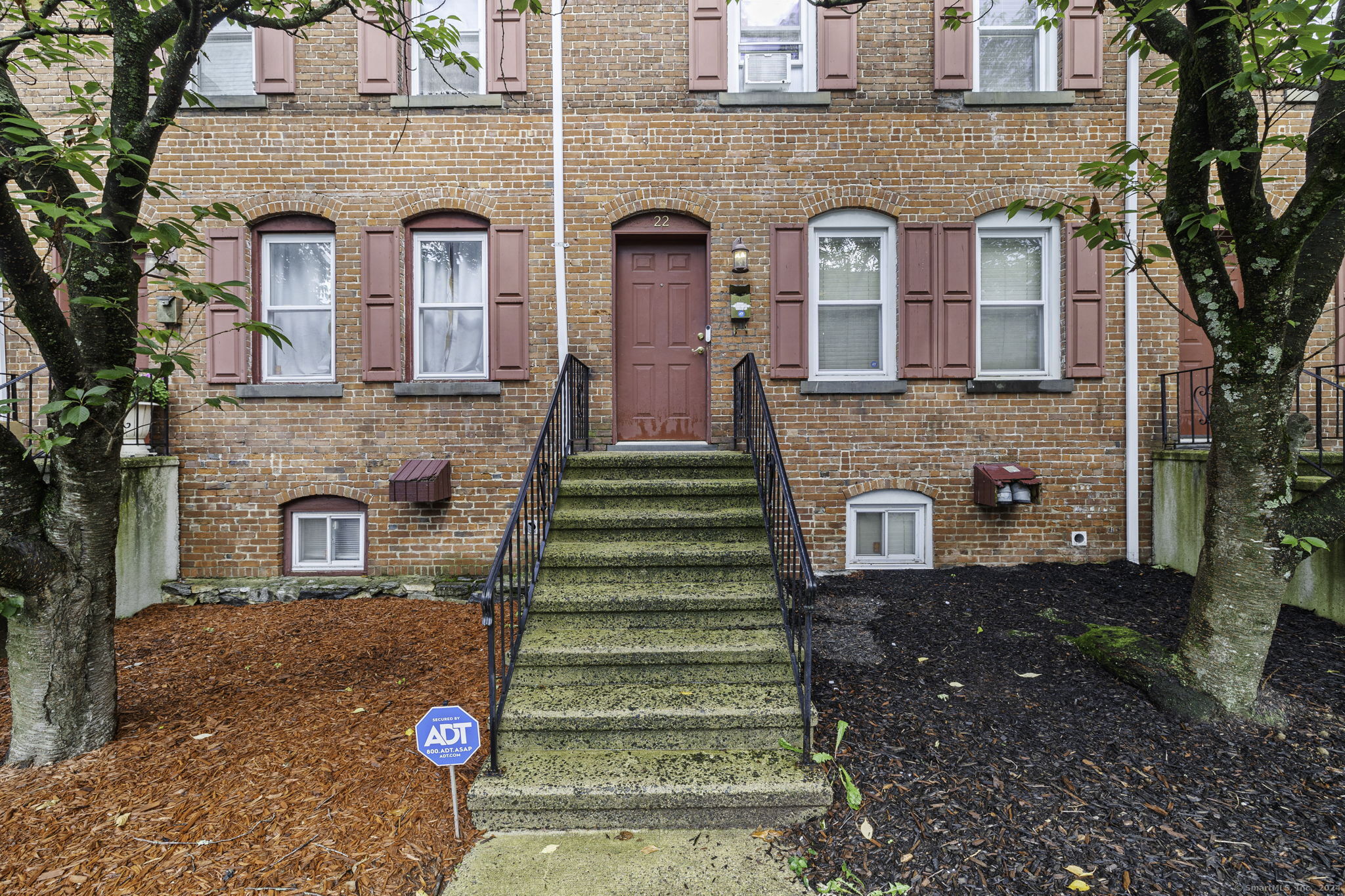 a front view of a house with a garden