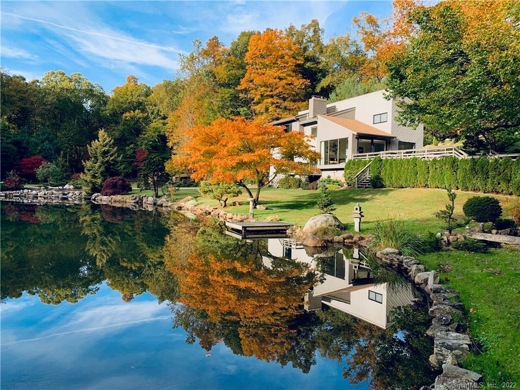 an aerial view of a house with yard swimming pool and outdoor seating