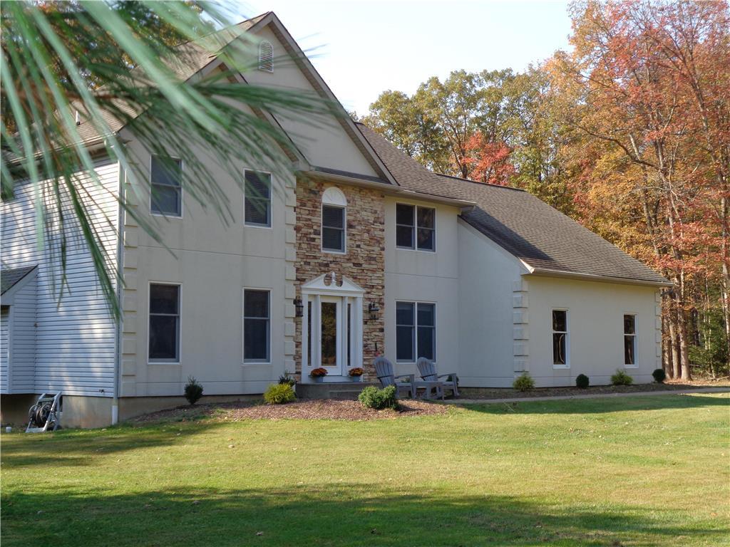 a view of a house with swimming pool and a yard