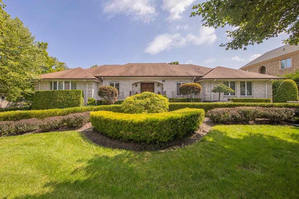 a front view of a house with a garden and plants