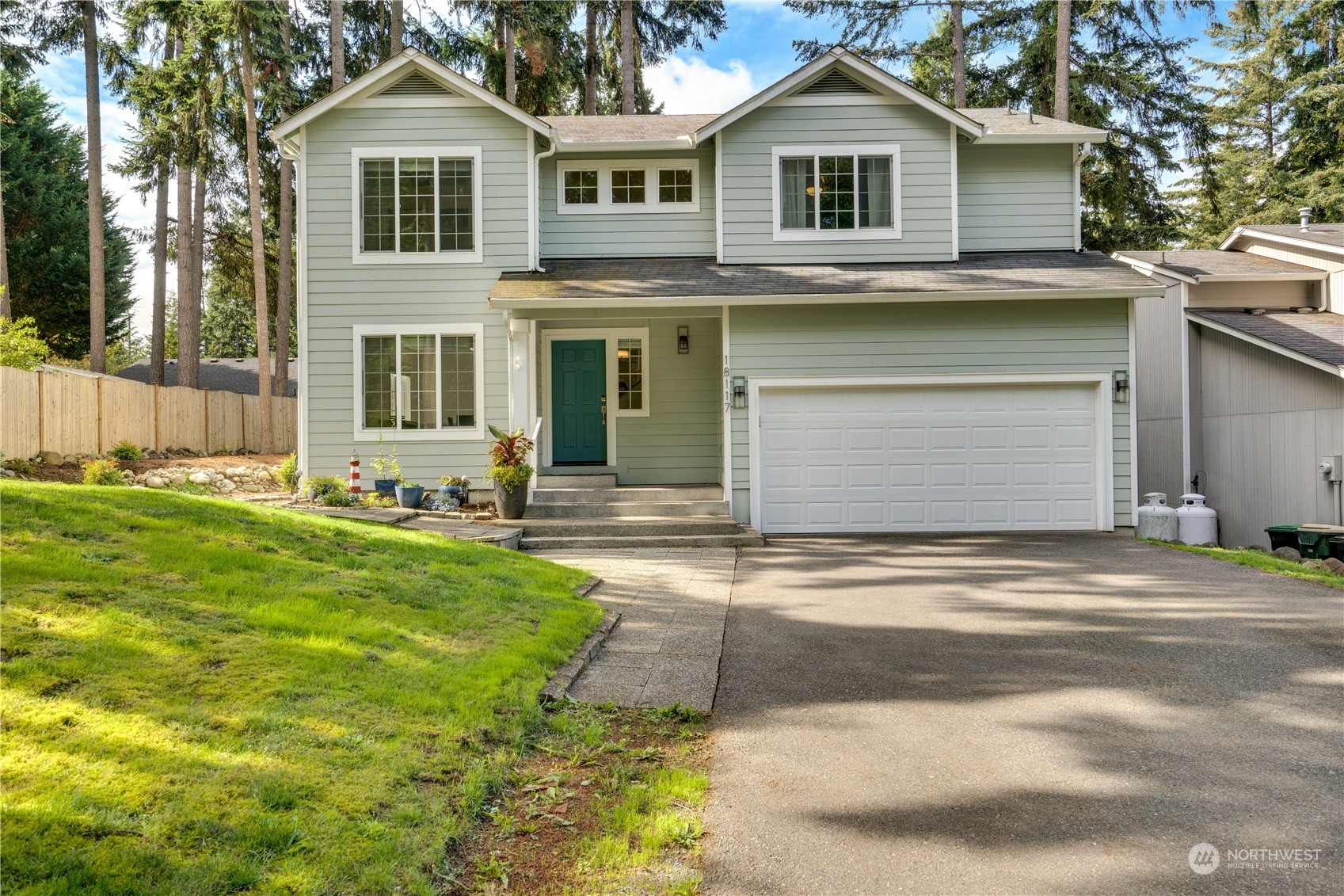 a front view of a house with a yard and garage