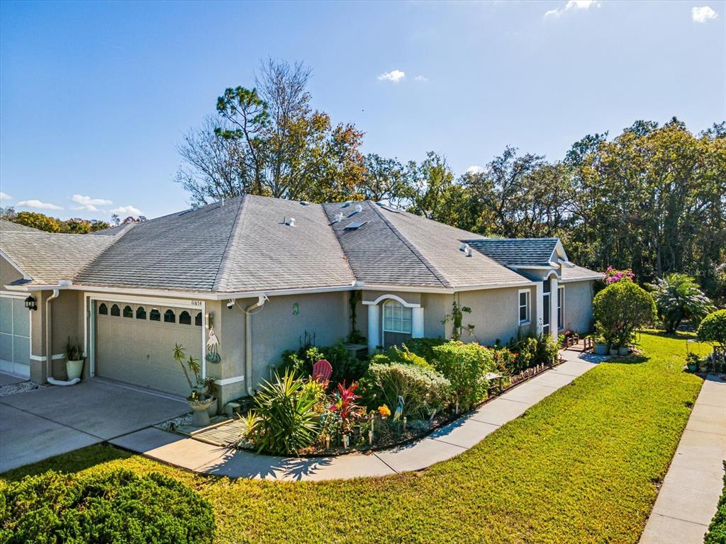 a front view of a house with a garden