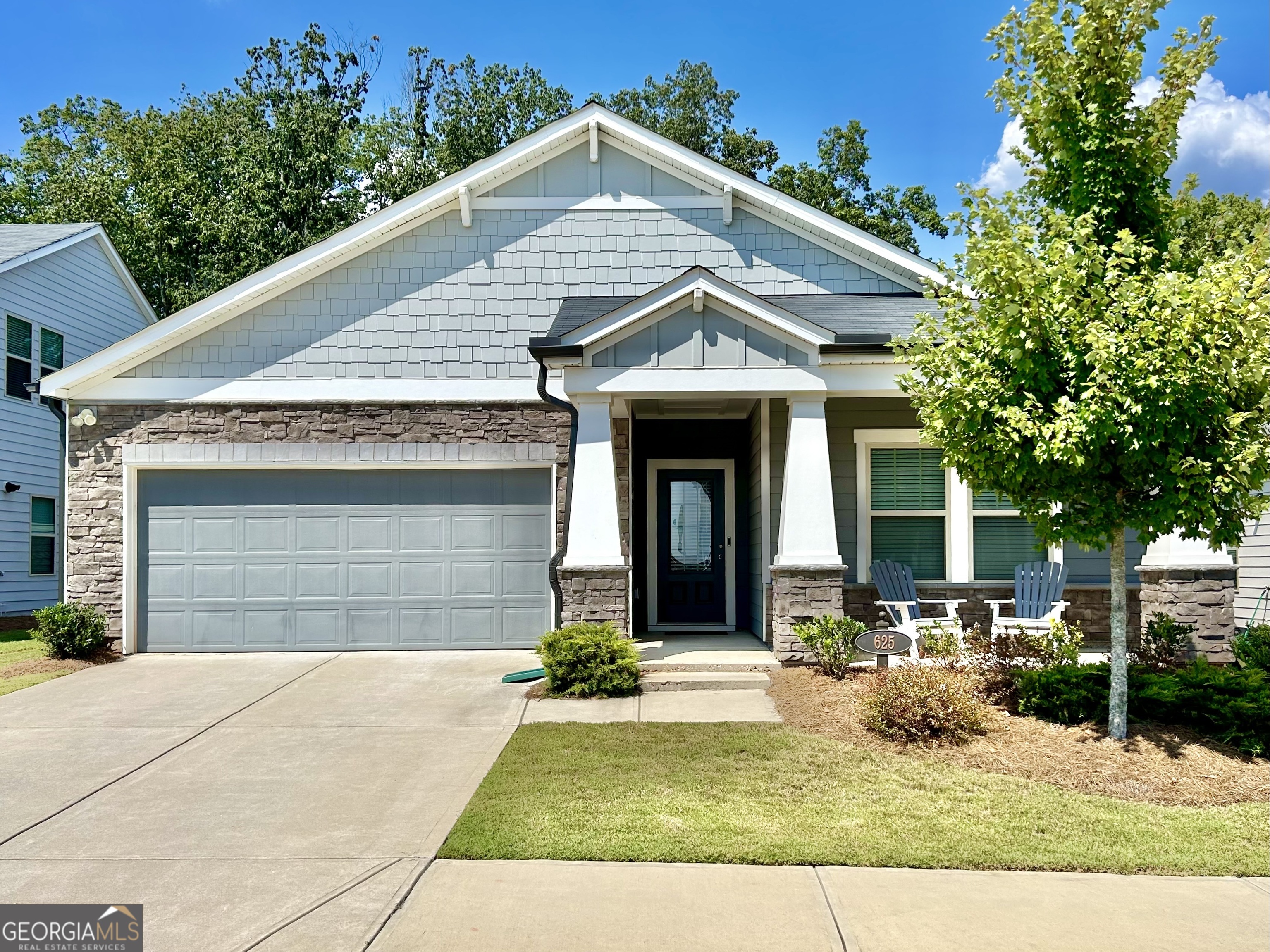 a front view of a house with garden