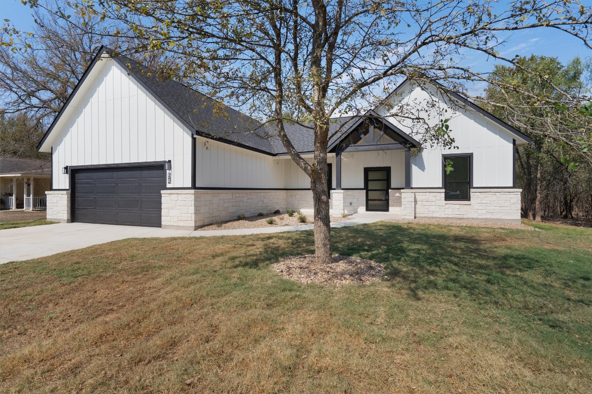 a front view of a house with a yard and garage