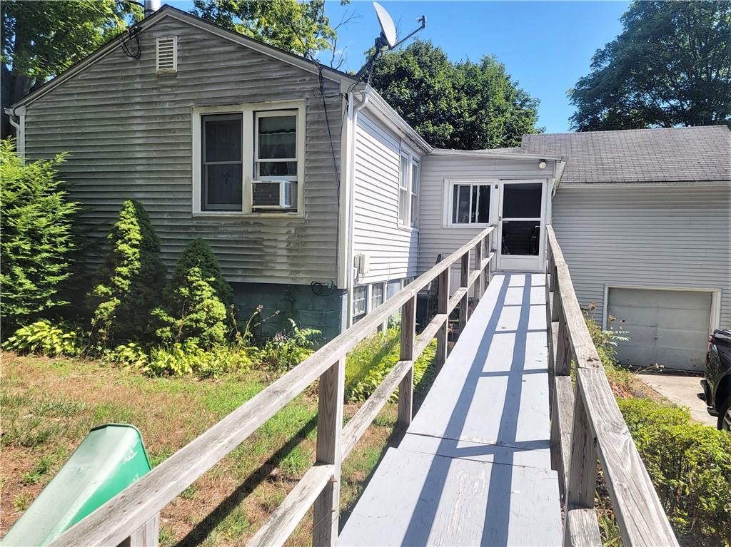 a view of house with wooden floor and fence