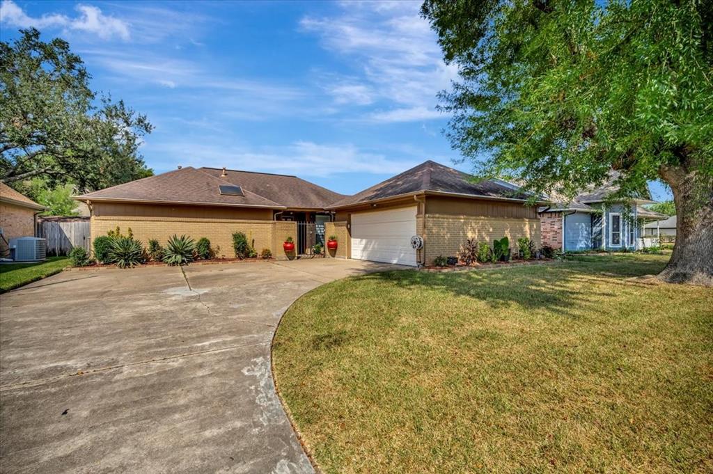 Beautiful home with attractive curb appeal, nestled under a majestic shade tree.