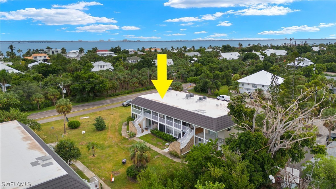 aerial view of a house with swimming pool and ocean view