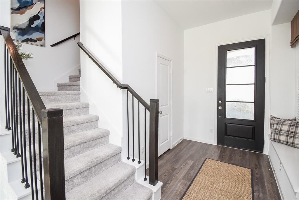 Upon entering the house, you're greeted by a spacious foyer that features a stylish staircase to one side and a conveniently located half guest bathroom nearby.