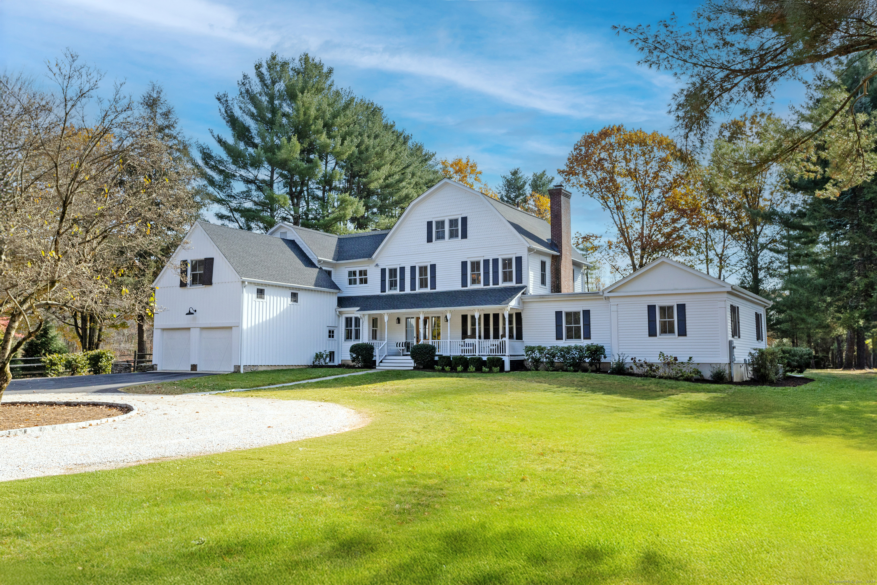 a view of a house with a big yard and large trees