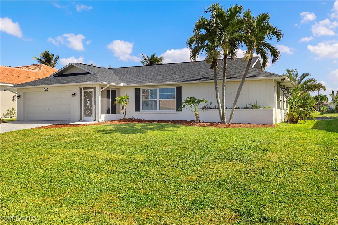 a front view of house with yard and outdoor seating