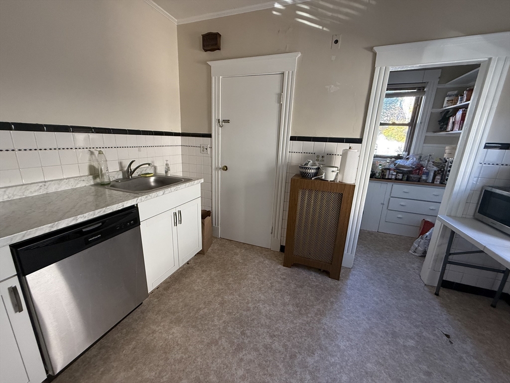 a view of a storage & utility room with cabinets