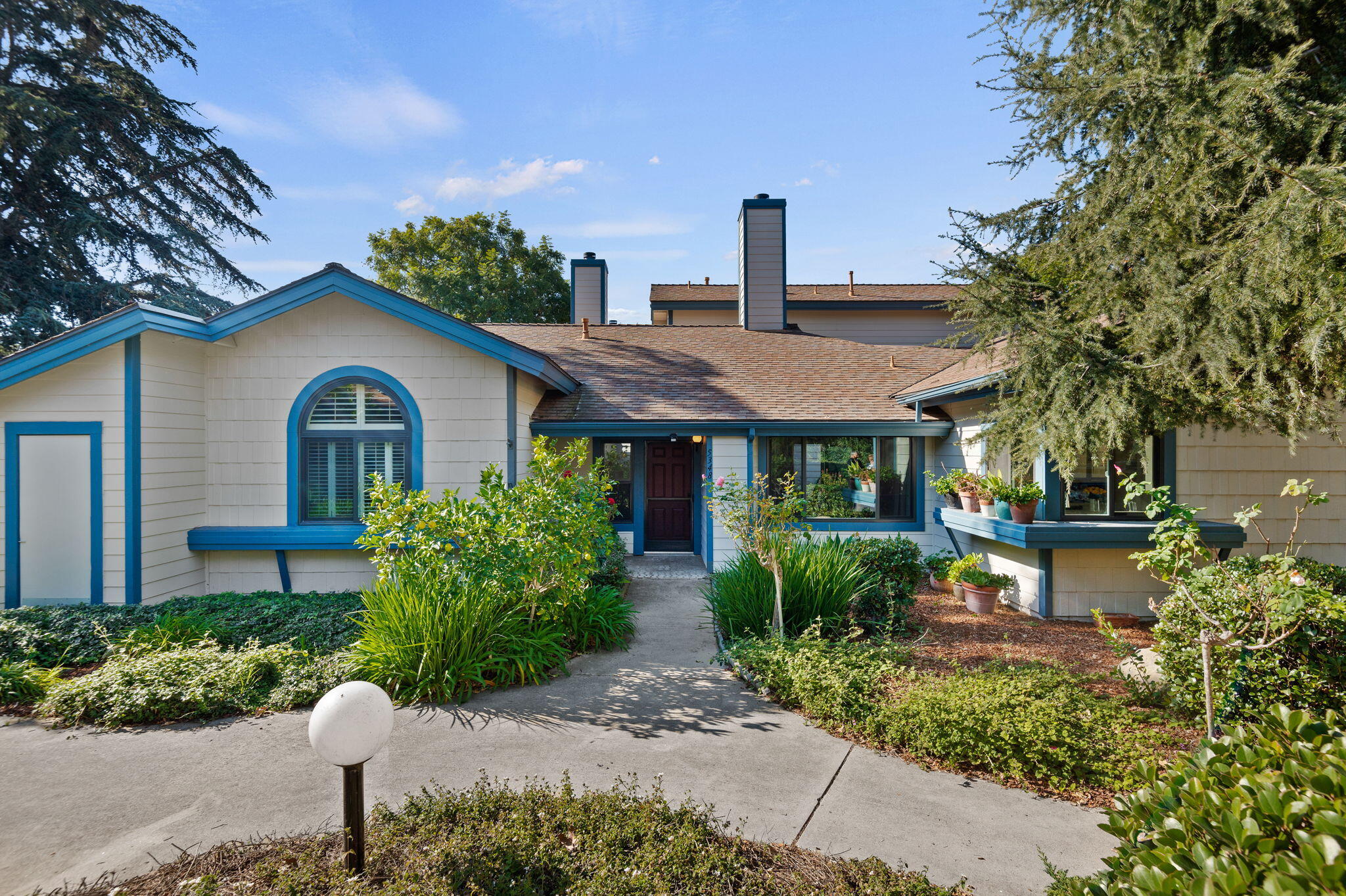 a front view of a house with garden