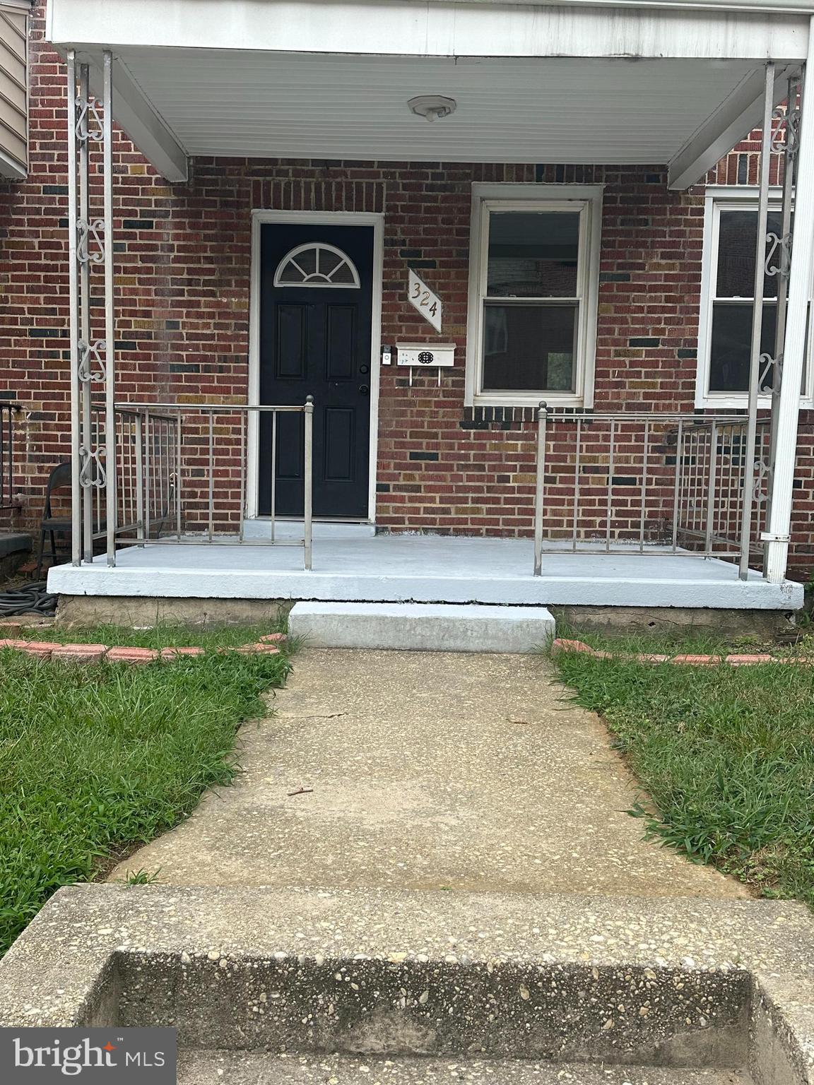 a view of front door of house with yard