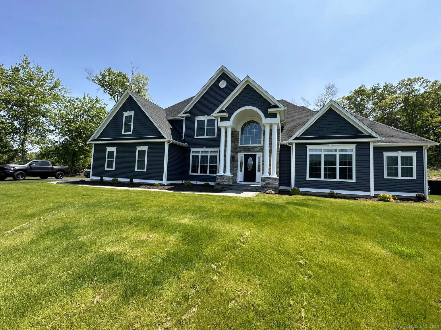 a front view of a house with a garden