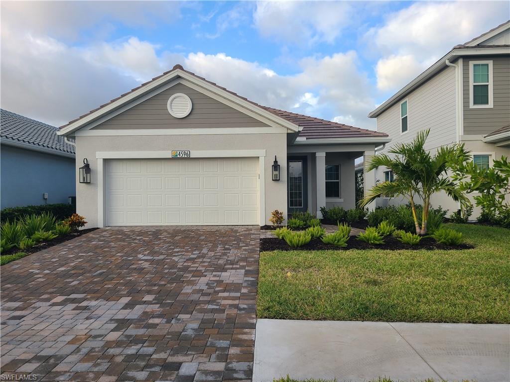 View of front of home with a front lawn and a garage