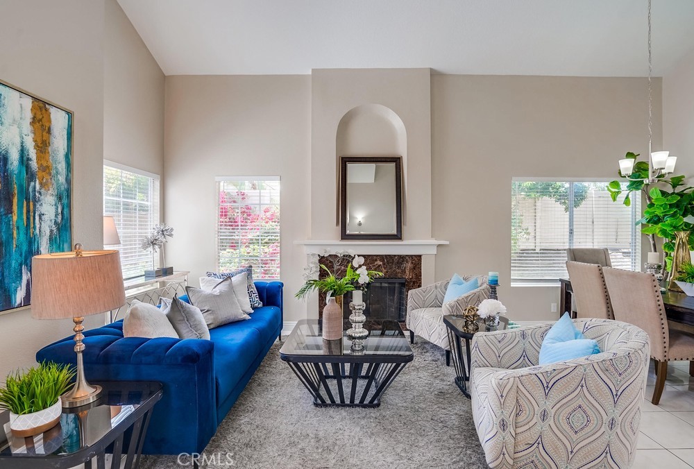 a living room with furniture and a potted plant