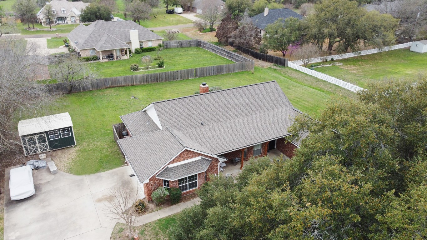 an aerial view of a house with garden space and street view