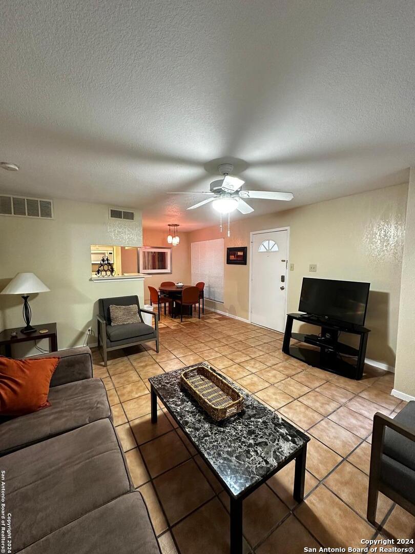 a living room with furniture and a rug