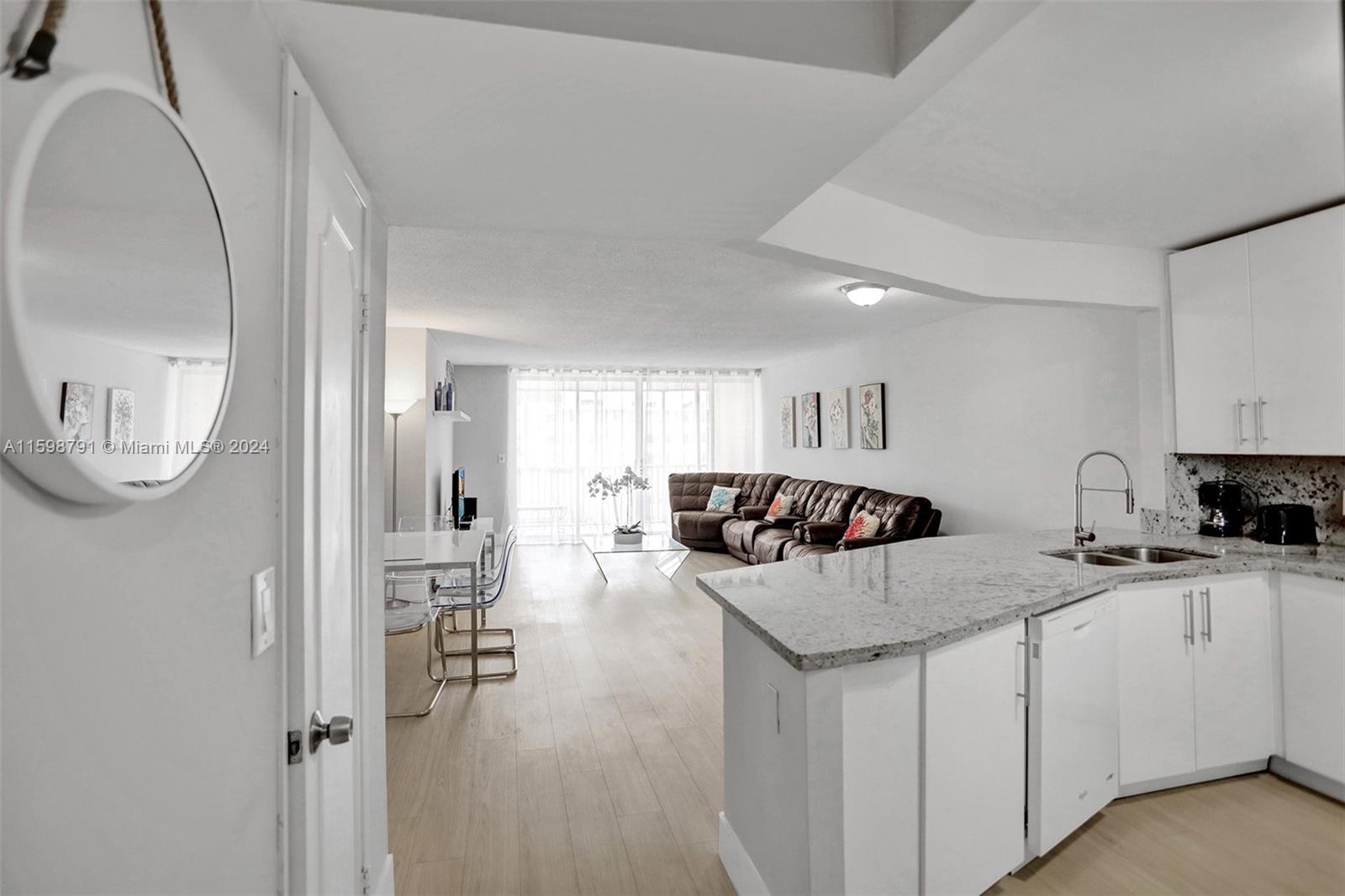 a kitchen with a sink a stove and cabinets