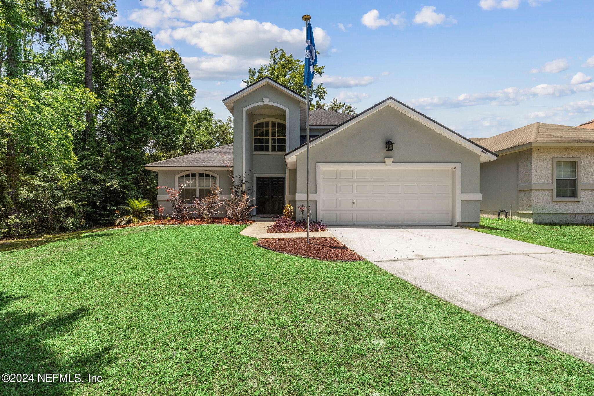 a front view of a house with a yard and garage