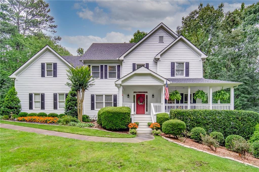 a front view of a house with a yard and porch