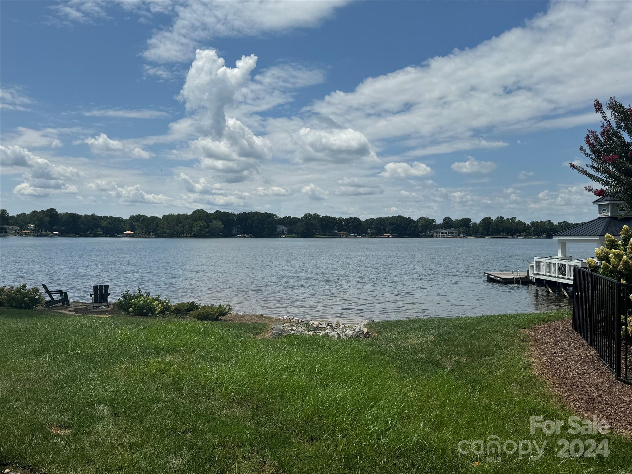 a view of a lake with houses in the back