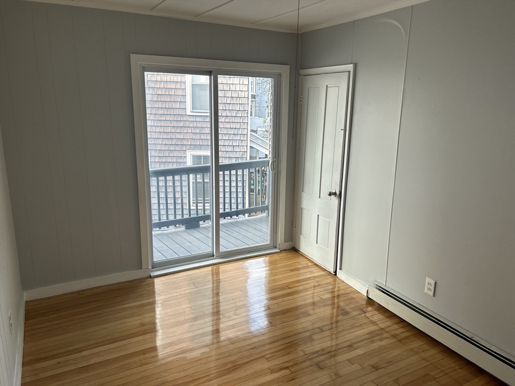 a view of a room with wooden floor