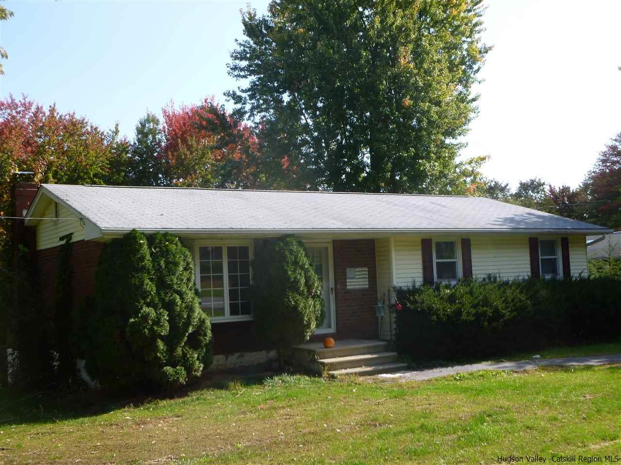 a view of house with yard and green space