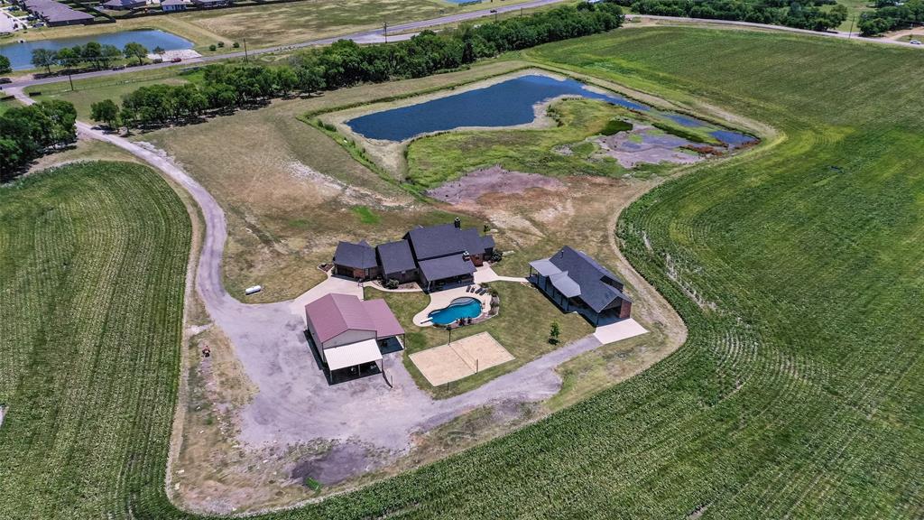 an aerial view of a house with a garden and swimming pool