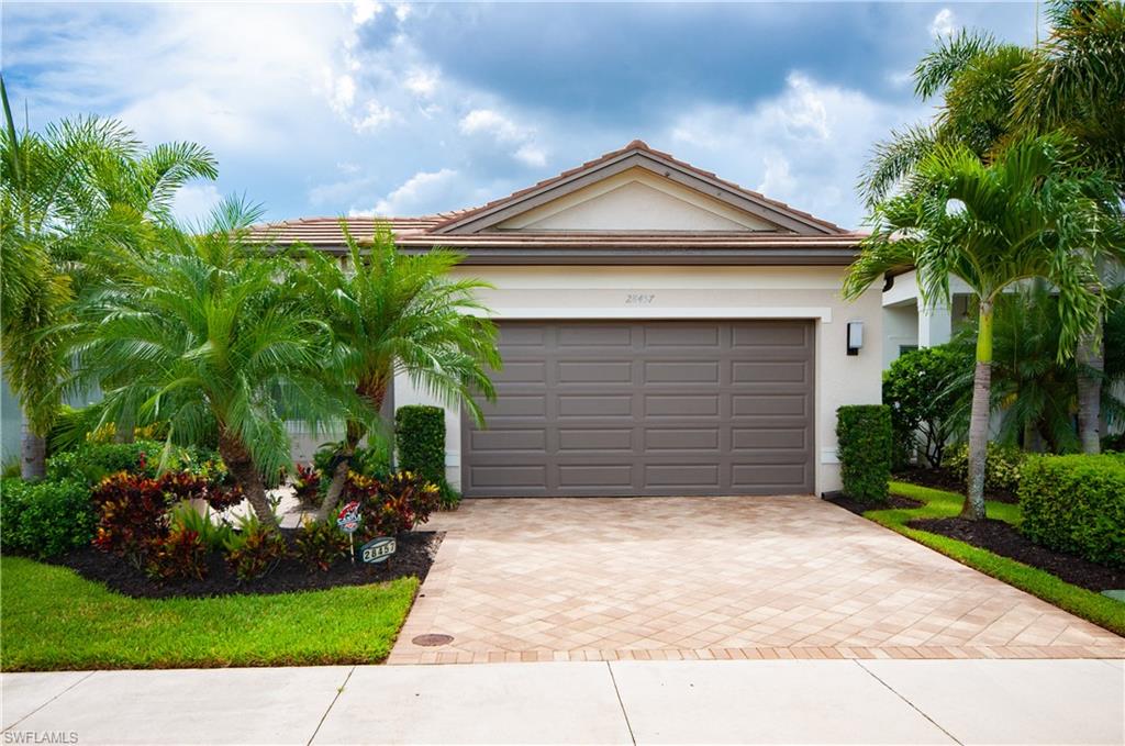 a front view of a house with a yard and garage