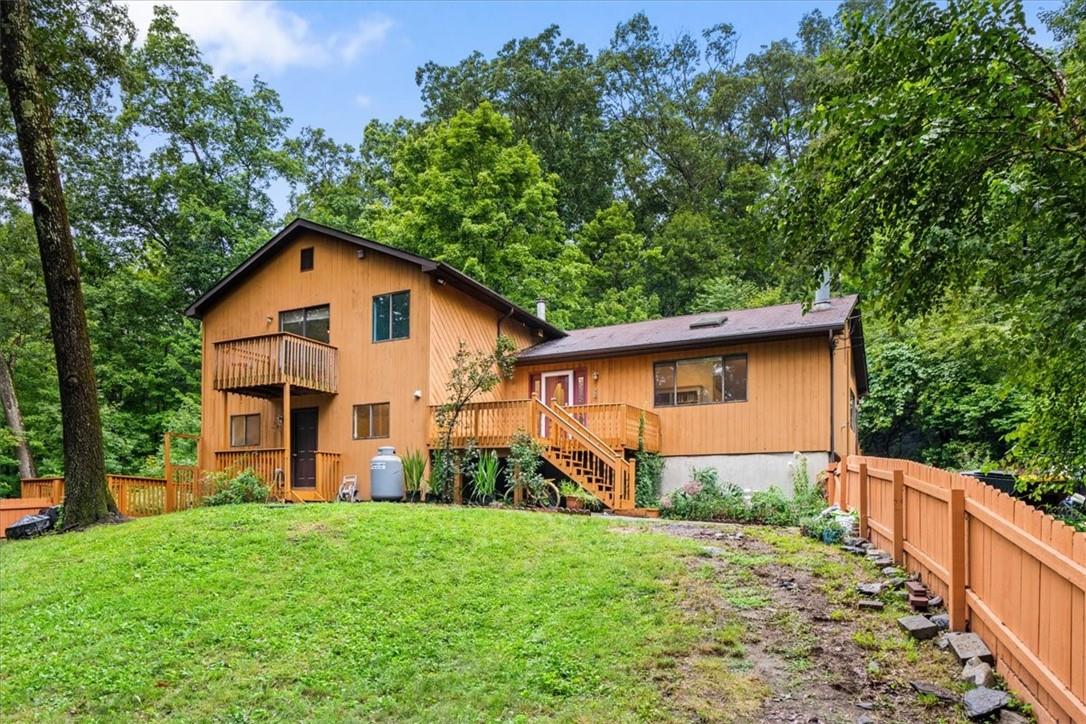 Rear view of property with a lawn