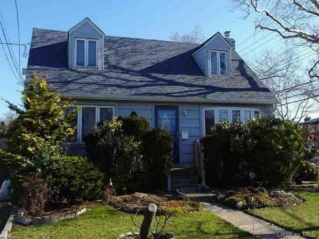 a house that has a tree in front of it