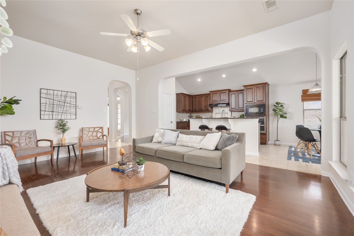 a living room with furniture and kitchen view