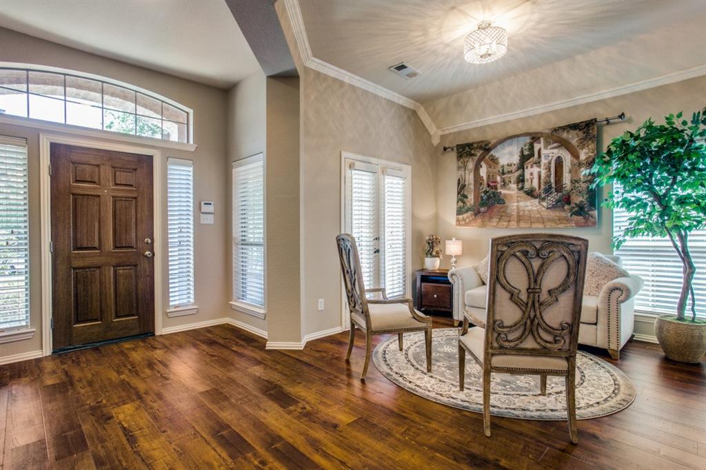 a living room with furniture a dining table with wooden floor and a fireplace