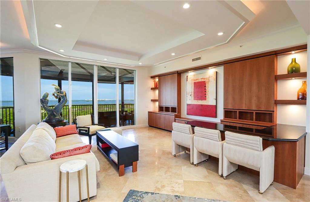 a living room with furniture a lamp and a large window