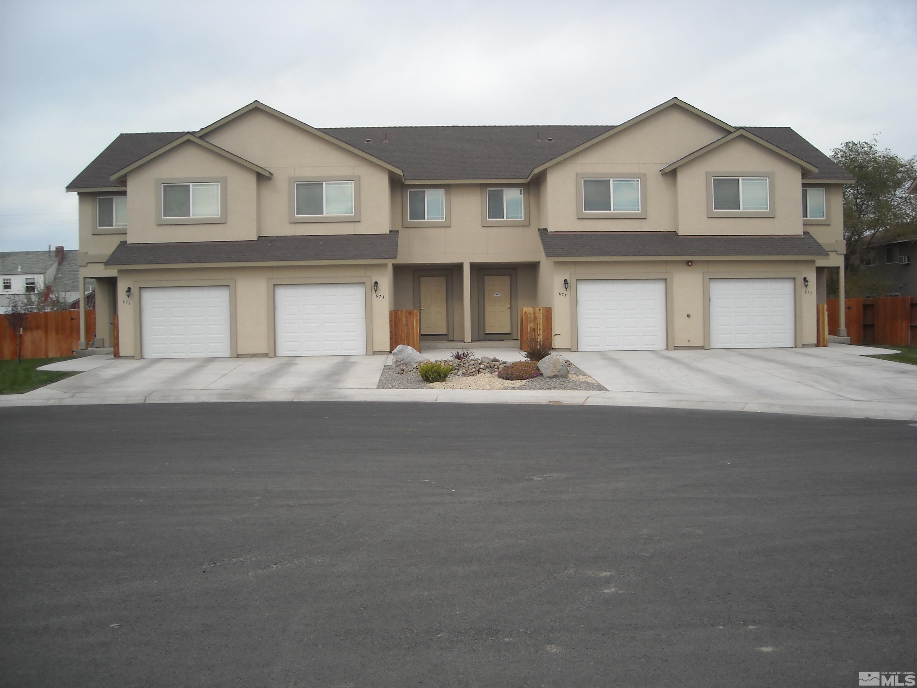 a front view of a house with a street