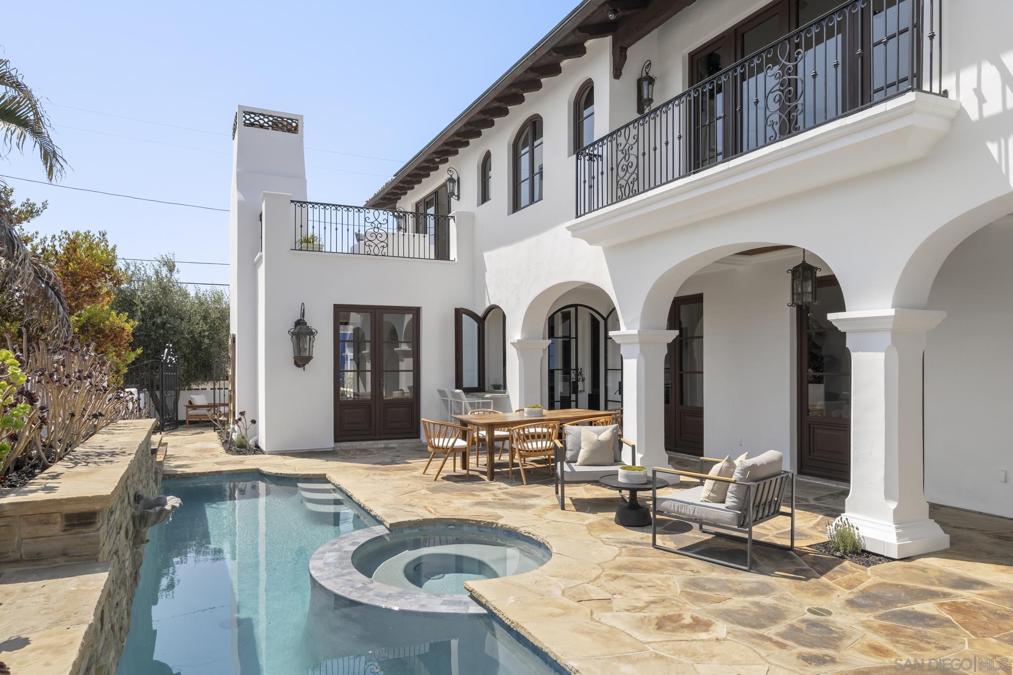 a view of a house with swimming pool and sitting area