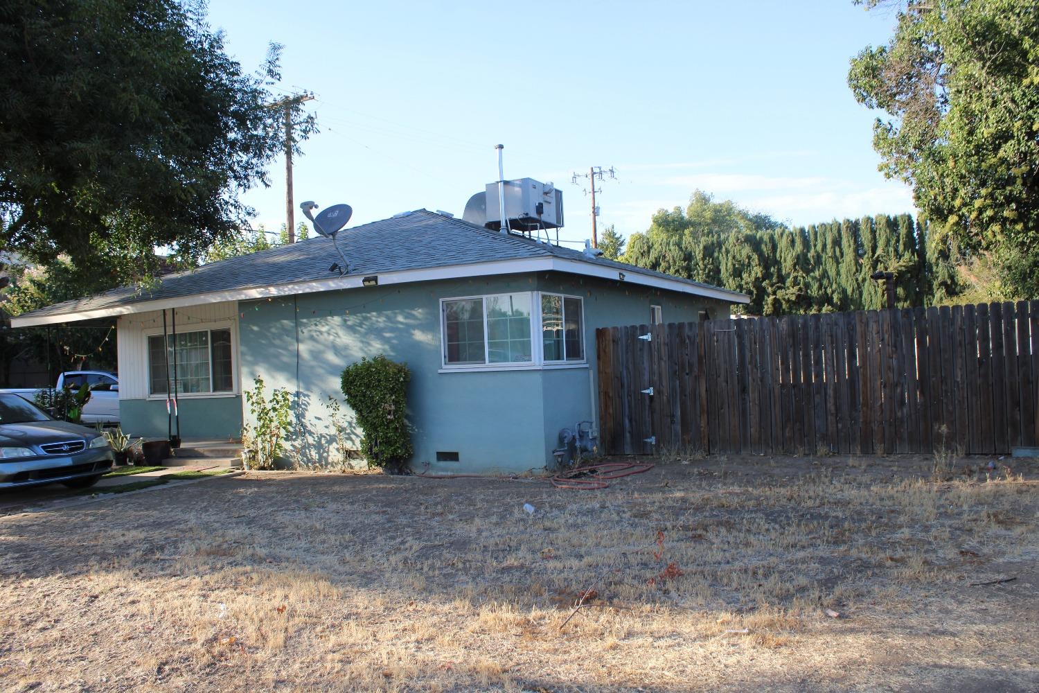 a view of a house with a yard and sitting area