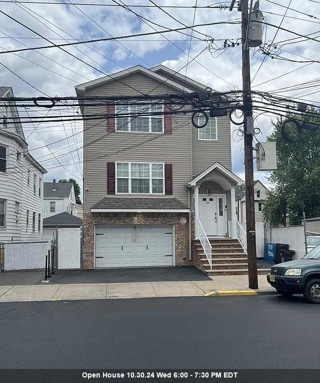 a front view of a house with a parking space